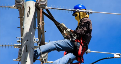 Person working on an electrical pole
