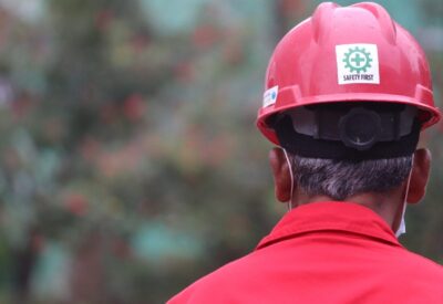 read view of person wearing a hardhat with a Safety First' sticker