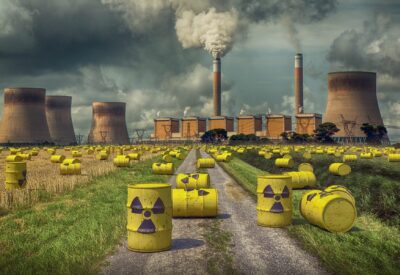 A nuclear power plant with many yellow toxin bins in a field