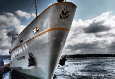 large ship in water at dock.